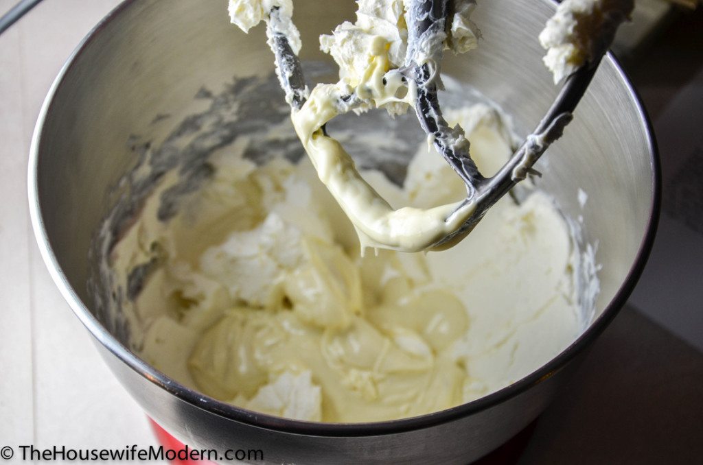 Beat room-temperature cream cheese and melted chocolate at medium speed until creamy, smooth, and light.
