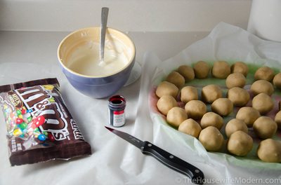 Prep: melt chocolate according to recipe directions. Have buckeyes and M&Ms ready.