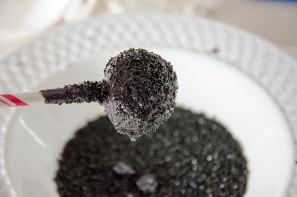 Spiders_prep5 Dip cake bites in melted chocolate. Then coat generously with black sprinkles.