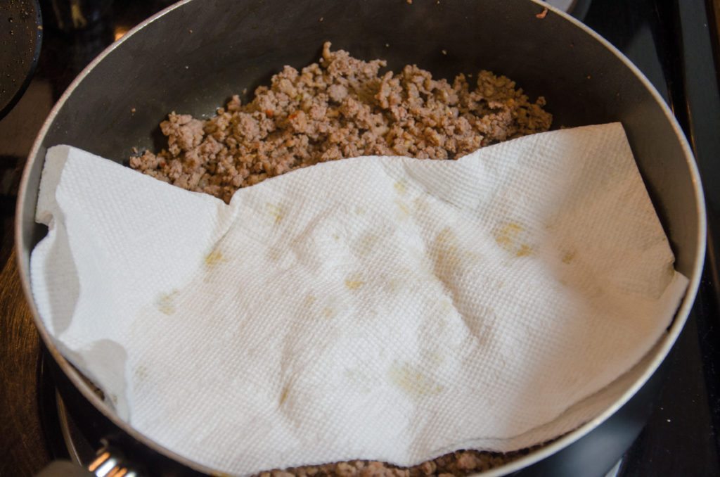 Brown beef and Italian sausage in a large pan. Drain of fat. With the Italian sausage, I usually press on it with a paper towel too.