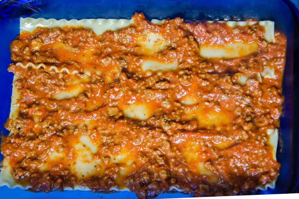 Smear sauce on top of the noodles.