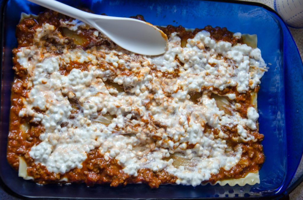 Spread 1/2 of cottage cheese. Sprinkle 1/3 of mozzarella and 1/3 of Parmesan over this.