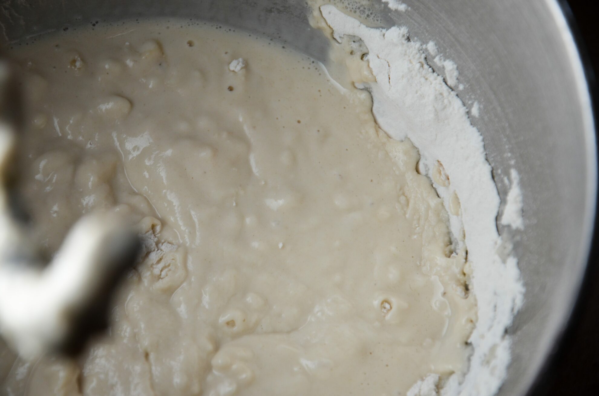 Add mixture in bowl to yeast. Knead on speed 2 for 1 minute.