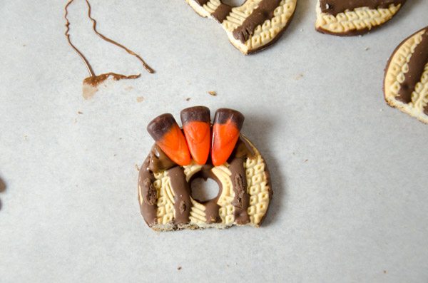 LR_Turkey Cake Pops_step2 prep-4 Then add another two on each side. Best technique is to press the edge of the candy corn closest to center down first..then "roll down" the rest, pressing the excess chocolate down instead of up between the corns.