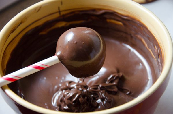 LR_Turkey Cake Pops_step3 prep-3 Carefully insert the cake ball into the candy coating by holding the lollipop stick and rotating until covered.