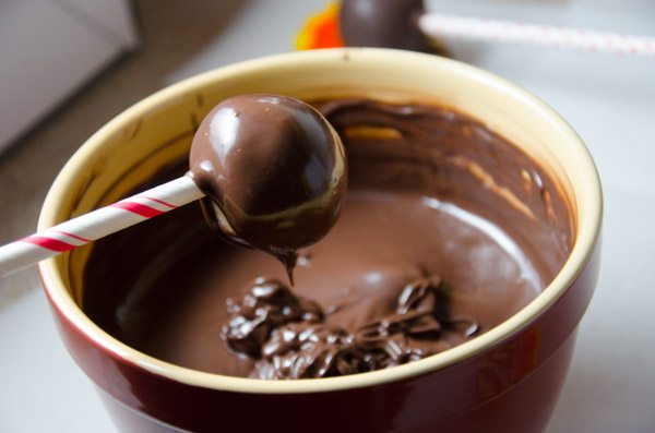 LR_Turkey Cake Pops_step3 prep-4 Once covered remove and softly tap and rotate until the excess chocolate falls off. Don’t tap too hard or the cake ball will fall off, too.
