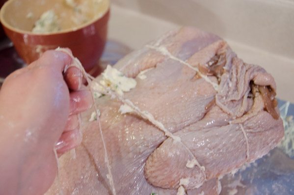 LR_Turkey, Cider Brined_prep-6 Wrap string around the turkey again, securing the other part of the wing (part towards the middle of the turkey). Tie another knot.