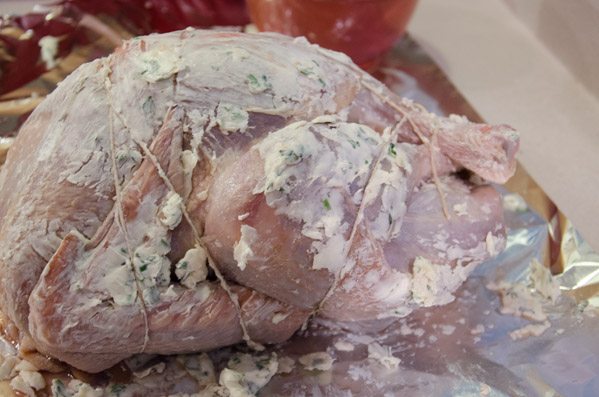 LR_Turkey, Cider Brined_prep-7 Tricky part: flip turkey over, pull string ends up from bottom of turkey, up and around legs. Make sure the thighs are secure. Tie legs down. One final loop tying leg ends together.