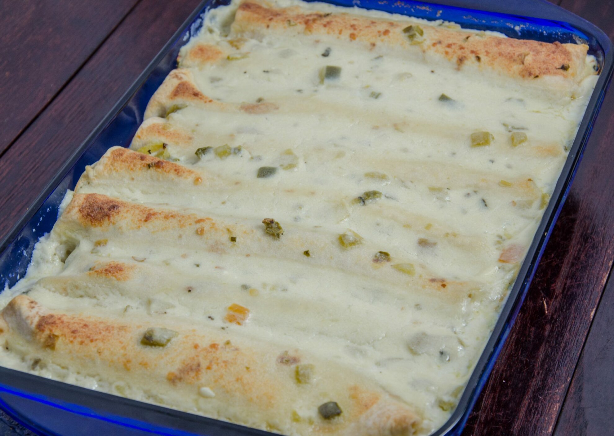 LR_White Chicken Enchiladas_overhead small-1 White Chicken Enchiladas Recipe. Enchiladas stuffed with chicken, beans, corn, and spinach covered with a creamy, delicious white sauce.