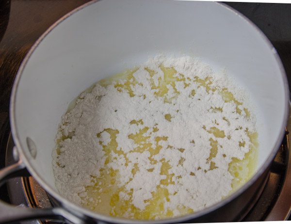 LR_White Chicken Enchiladas_prep-6 Melt butter on medium-low. Sprinkle flour over it. Whisk to combine.