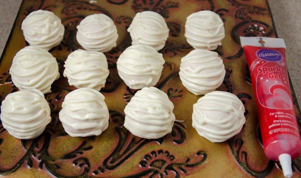 LR_Mummies_prep14 Decorated with white chocolate. Allow to harden, then dab on "eyes" with red sparkle gel.