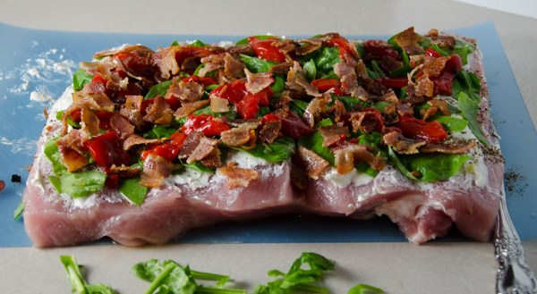 Tuscan-Style Pork Loin: tender, moist, & flavorful. Pork stuffed with cream cheese, bacon, pesto, roasted peppers, and more.