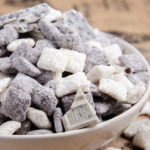 Cookies and cream muddy buddies in a white bowl and burlap background.