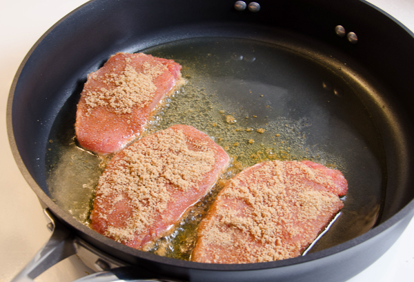LR_Sweet & Spicy Pork Chops_prep-1 Mise en place. Preheat oven to 350°. In a bowl, combine brown sugar and spices. Heat skillet over medium heat. Add thin layer of oil. Rub pork chops in sugar/spice seasoning mix. When the oil is hot, add the pork chops.