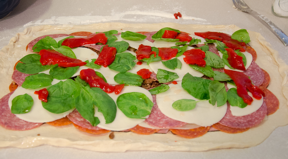 Roll out dough. Layer ingredients. Feel free to use more or less to your taste.