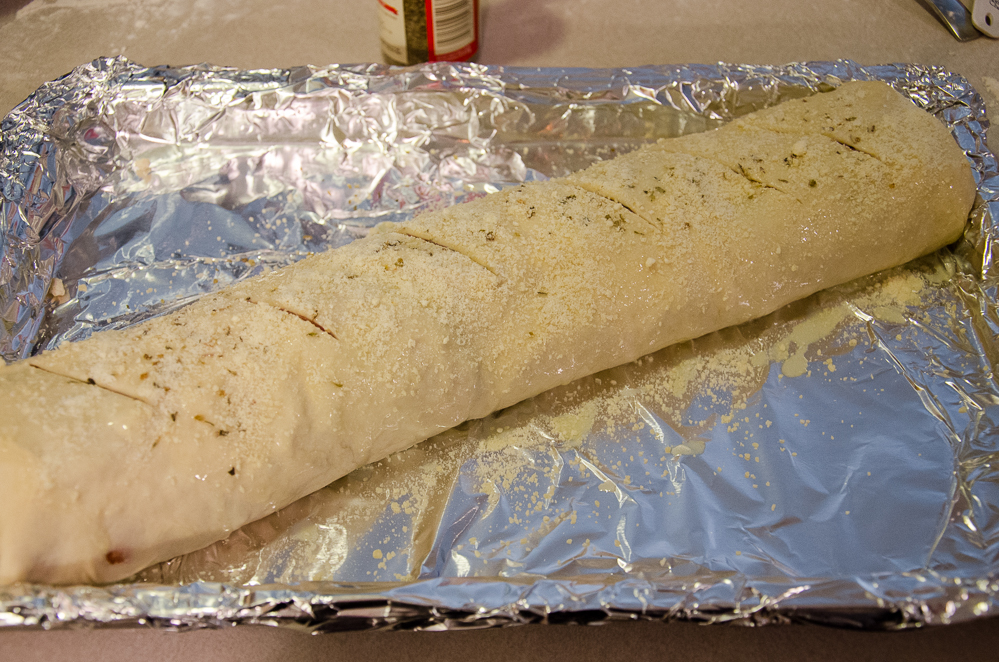 Roll. Spread with melted butter and sprinkle with parmesan, oregano, and garlic powder.
