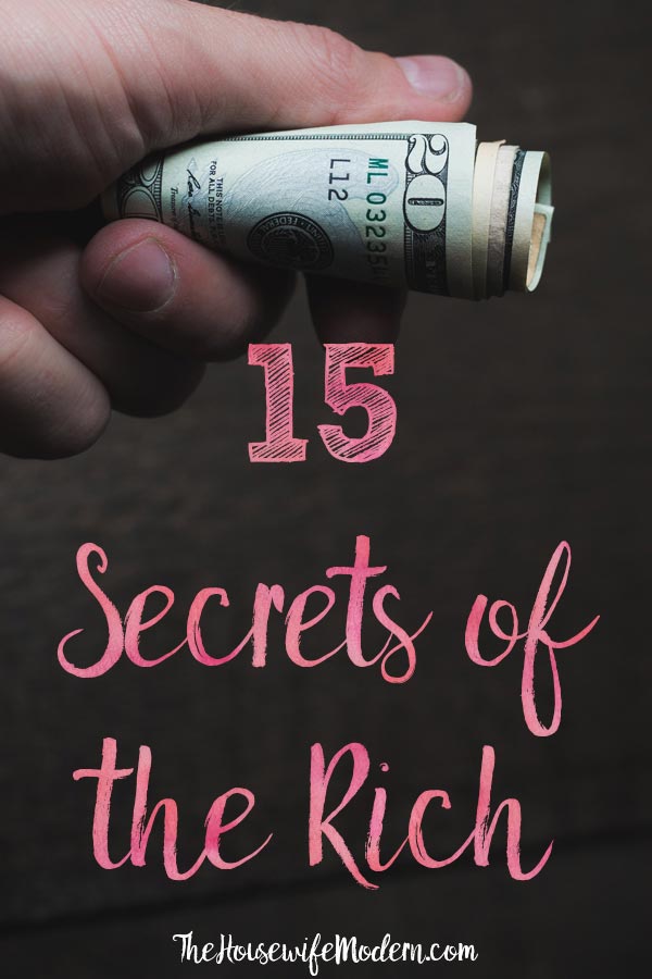 Pin image for secrets of the rich. Hand holding tightly rolled money with text overlay.