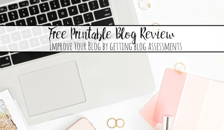 Featured image for free printable blog review. Pinkish computer, notepads, with text overlay.