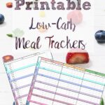 Pin image for free printable low-carb meal trackers. Image of two trackers over fruit with text overlay.
