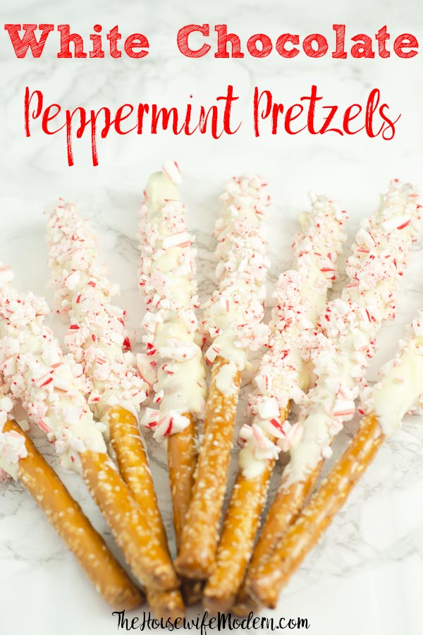 Pin image for white chocolate peppermint pretzels. Pretzels spread out over white marble with text.
