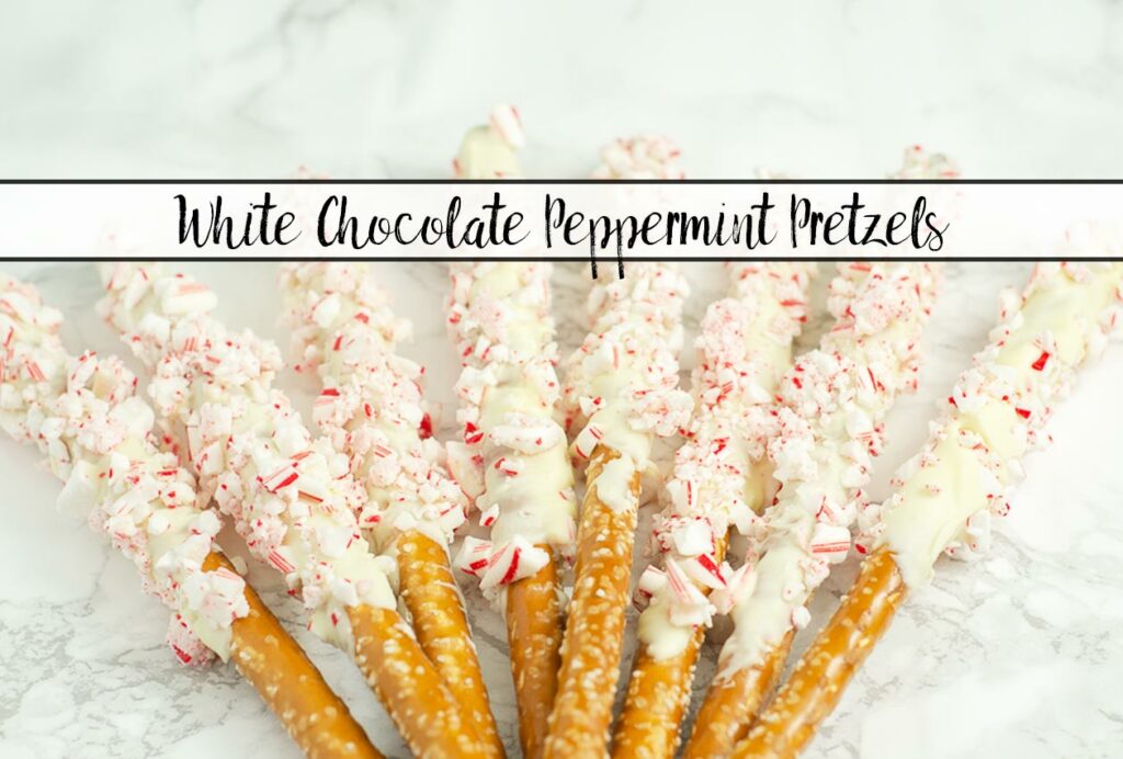 Featured image for white chocolate peppermint pretzels. Pretzels spread out over white marble with text.