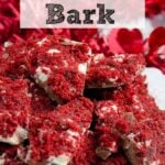 Pin image for red velvet bark. Close-up of bark piled on white plate with red tinsel in background with text overlay.