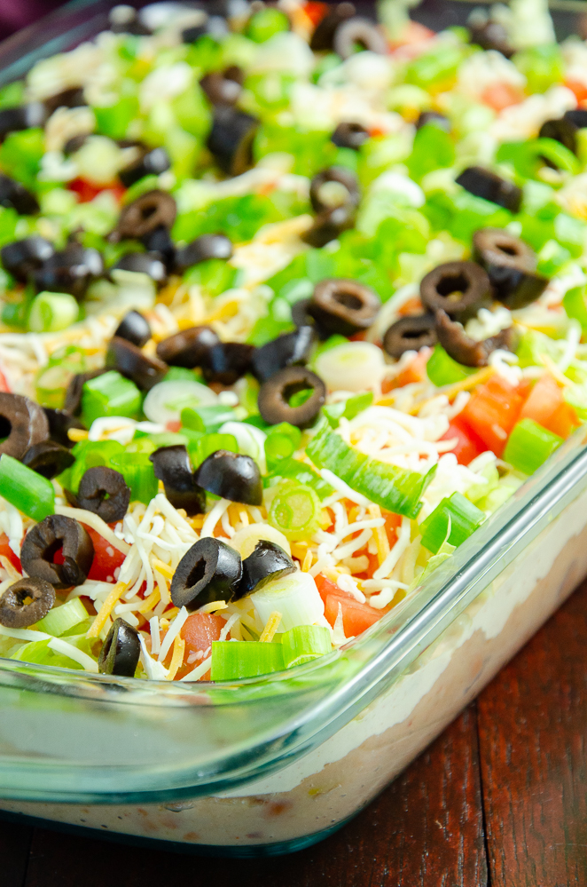 Vertical view of 7 layer dip. Clear dish, focus emphasized on front.