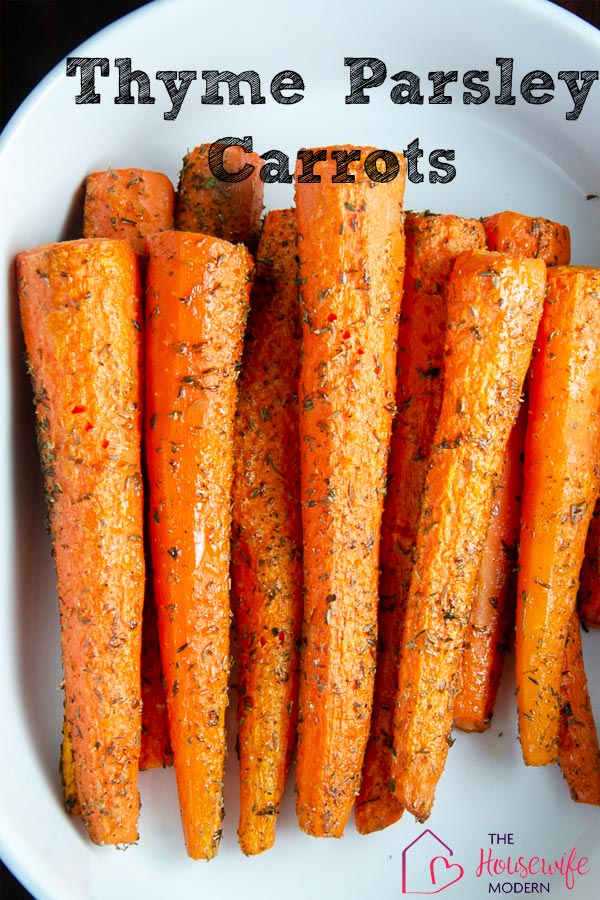 Roasted Carrots with Parsley and Thyme. View of all carrots in white serving dish.