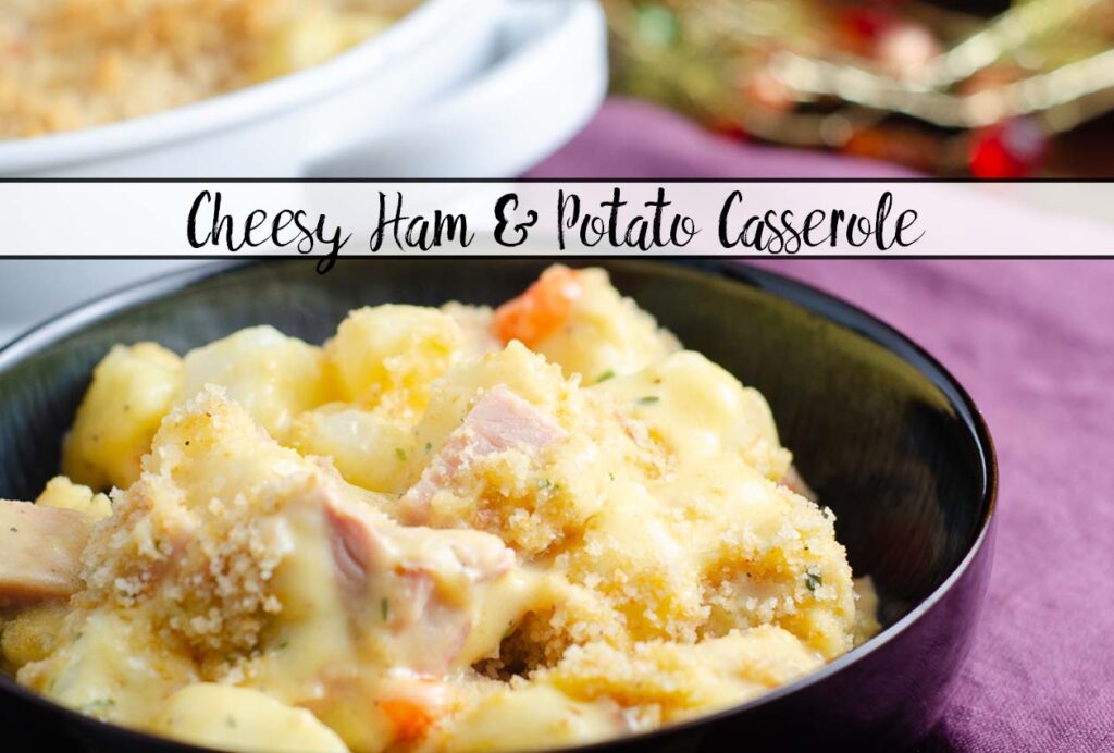 Featured image for cheesy ham and potato casserole. Blue bowl full of casserole with purple napkin in background.