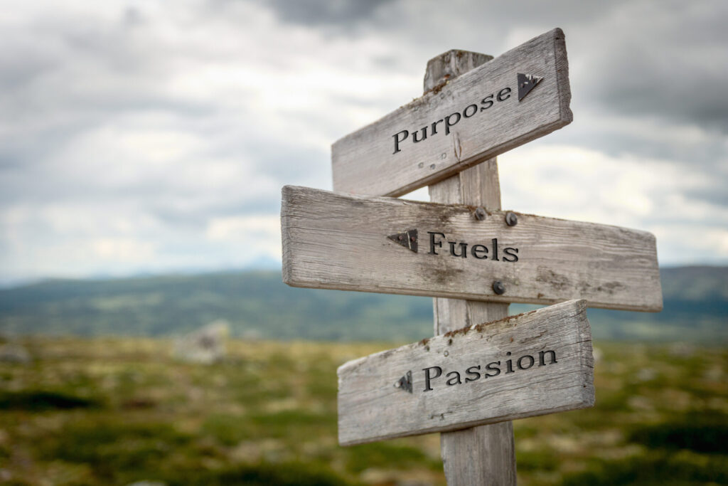 Purpose, Fuels, Passion on a wooden sign post