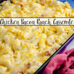 Featured image. Casserole in large blue casserole dish with red cheesecloth