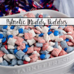 Featured image. Patriotic muddy buddies in white oval dish with sparkle wreath in background.