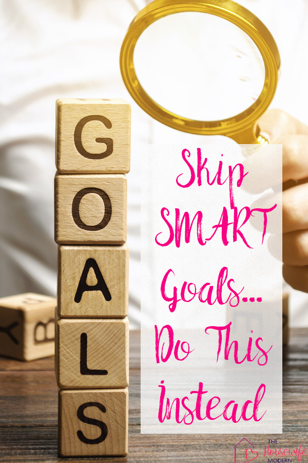 Pin mage for why smart goals don't work. Magnifying glass examining stack of wooden blocks that says goals with text overlay