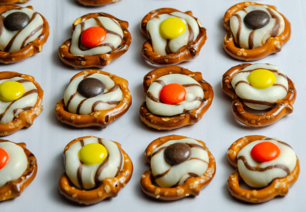 These easy fall pretzel kisses combine salty pretzels, chocolate Kisses, and Reese’s Pieces for a simple sweet-and-salty fall treat perfect for parties or Thanksgiving.