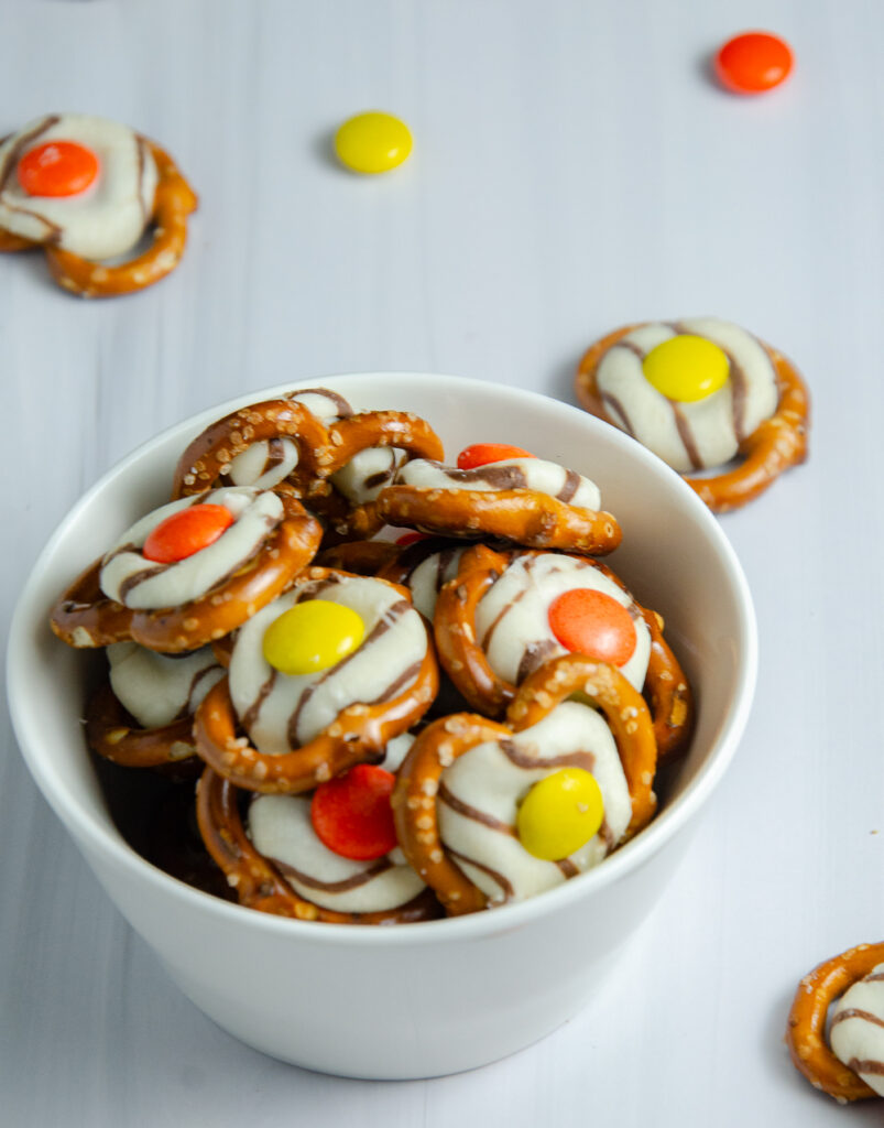 These easy fall pretzel kisses combine pretzels, striped Hershey's Kisses, and Reese’s Pieces for a colorful sweet-and-salty snack. These simple fall pretzel treats are perfect for autumn parties, after-school snacks, or Thanksgiving gatherings.