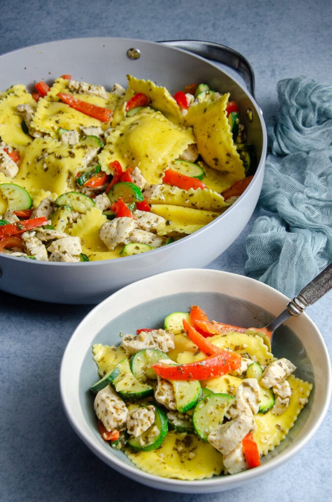This easy pesto ravioli with chicken is a simple weeknight dinner made with cheese ravioli, basil pesto, chicken, zucchini, and red pepper. A quick and flavorful ravioli recipe that's perfect for busy nights.