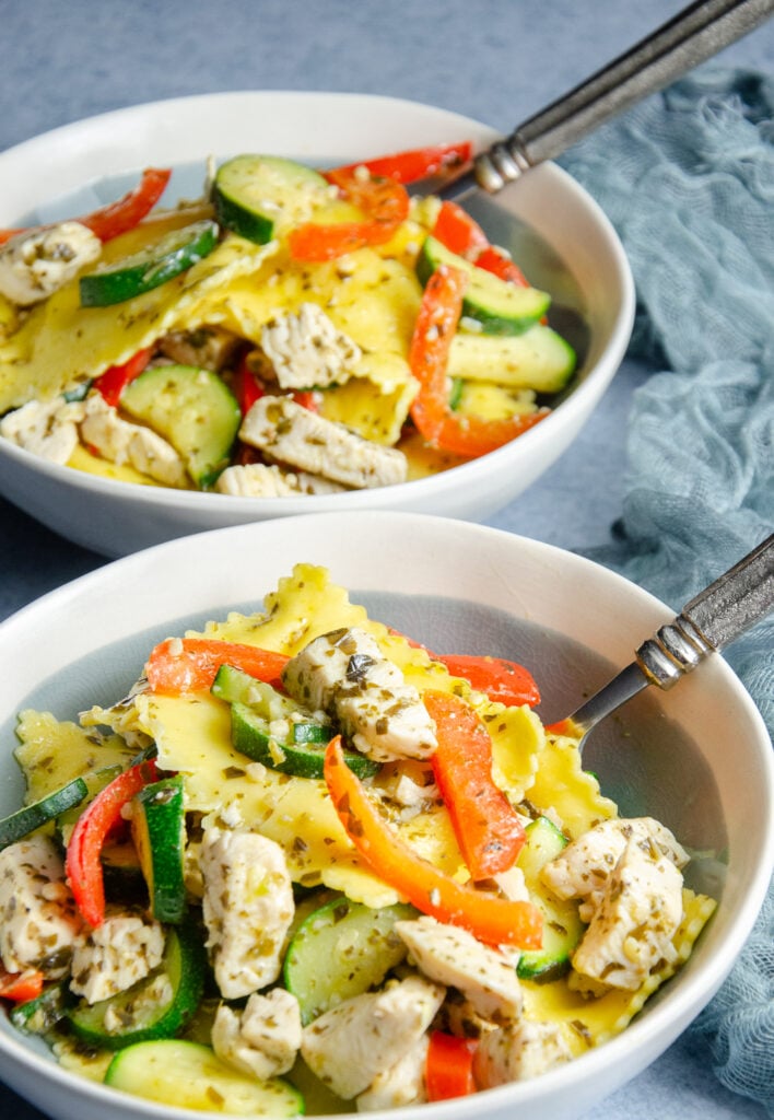 Looking for an easy weeknight dinner? This pesto ravioli recipe combines cheese ravioli with chicken, zucchini, red pepper, and basil pesto for a quick pasta dinner the whole family can enjoy.