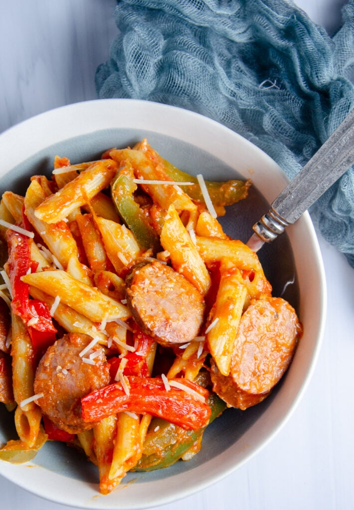 Smoked kielbasa, tender penne, bell peppers, and onions come together in a flavorful tomato sauce for a simple, hearty dinner. This kielbasa pasta recipe is perfect when you need a satisfying, easy, delicious weeknight meal.